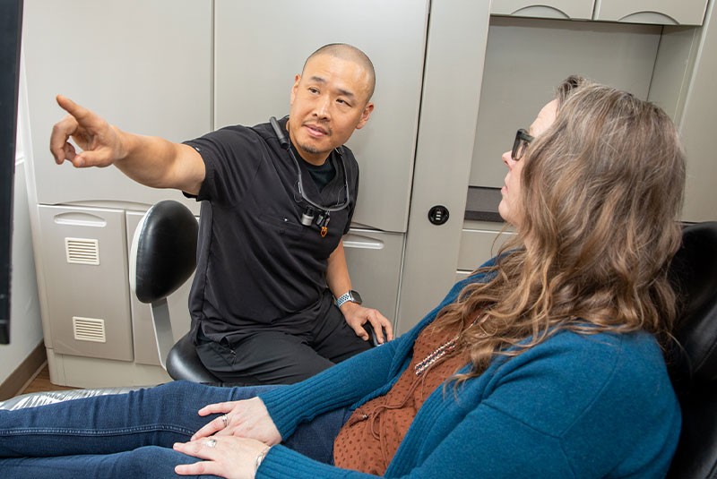 doctor showing dental images to patient for dental procedure