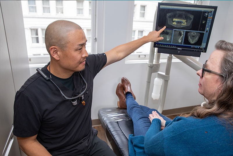 docotor presenting imaging for dental procedure for patient